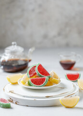 Fruit marmalade on white background. Slices of marmalade sprinkled with granulated sugar
