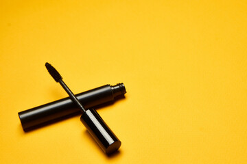 cosmetics mascara brushes decoration accessories yellow background