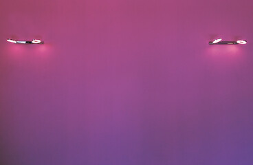Gradient purple pink lilac background on the wall with lamps.