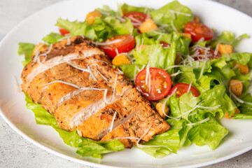 Homemade salad Caesar with fried chicken. Vegetables and chicken close up photo