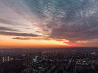 Aerial scenic vivid colorful sunset panoramic view with epic skyscape. Kharkiv city center, Pavlove pole residential district streets and buildings in evening light