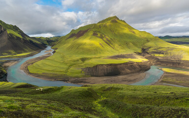 Green mountains and river in icelandic highlands during summer