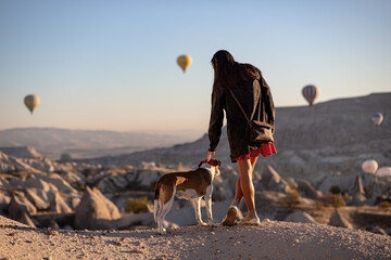 a girl with a dog on the background beautiful landscape in the cappadocia valley in the morning at...