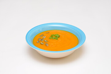 pumpkin soup in a bowl on a white background