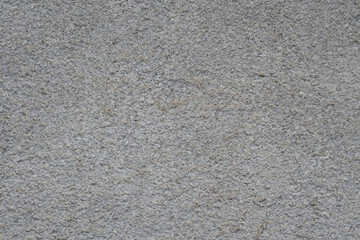 Gray stucco textured wall background with natural light.