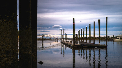 Abstract geometry and reflections of the pilings of the commercial dock under the bridge in the South River.