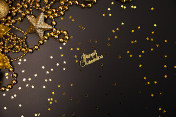Christmas golden decorations with gift boxes on dark background. Template for greeting card