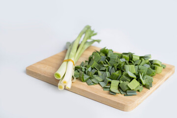 fresh leeks on wooden cutting board