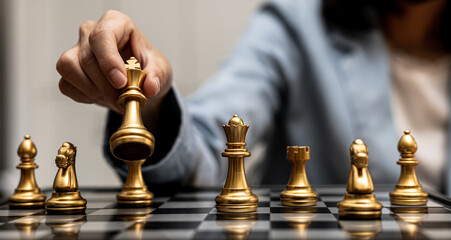 Person playing chess board game, business woman concept image holding chess pieces like business competition and risk management, planning business strategies to defeat business competitors.