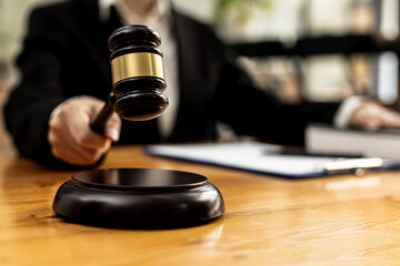 A person holding the hammer of justice, the concept of a lawyer or a law enforcement officer is holding a hammer similar to the judgment of a lawsuit.