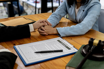 Lawyers shake hands to encourage clients who come to join the case of embezzlement from business...