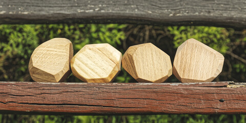 Wooden irregular blocks of different wood types next to each other. Four wooden stone toy blocks...