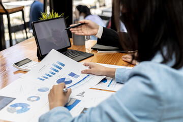 Fototapeta premium Meeting room atmosphere, business people meeting together on finance topics, they are working together to plan and solve corporate finance issues. Concept of business administration and finance.