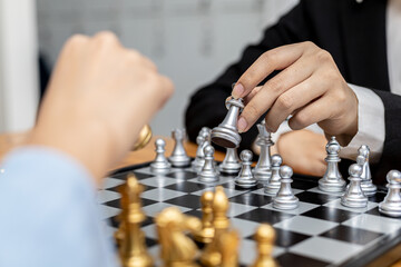 Two people playing a game of chess, concept image of two businessmen playing chess compared to a business competition that requires strategic planning and risk-based business management.