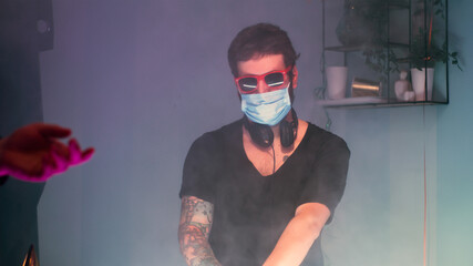 DJ in mask working during pandemic party