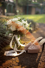 wedding bouquet of flowers and shoes on the ground