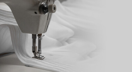 Cloth in a typewriter. A seamstress works on a sewing machine with white curtains. There is a place...