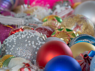 Background of beautiful Christmas balls and toys. Christmas background. Happy New Year. Pastel background with colorful Christmas toys and balloons, focus in the foreground