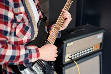 Playing guitar and concert concept. Repetition of rock music band. Man of electric guitar player....