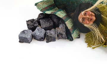 Befana sock with sweet coal candies on white background. Italian Epiphany day tradition.