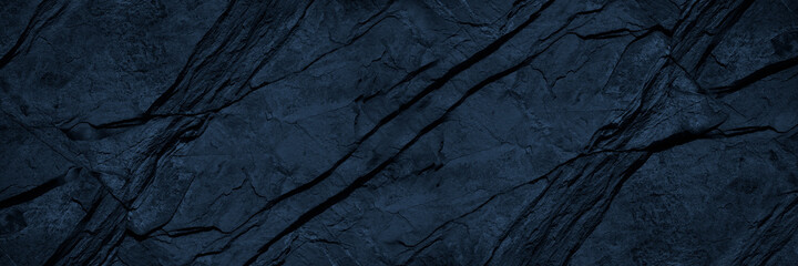 Black blue rock texture. Toned mountain surface. Macro. Dark volumetric stone background with copy space for design. Wide banner. Panoramic.