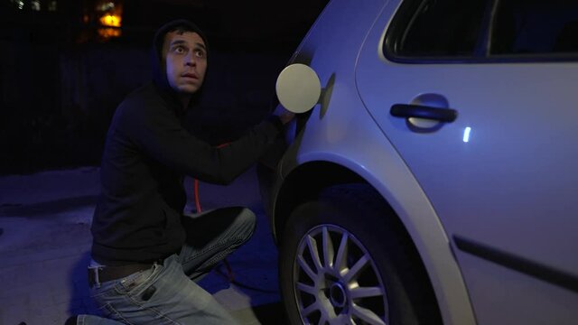 Thief drains gasoline from a car