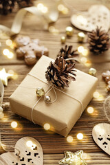 christmas card with gift box, gingerbread cookies and christmas ornaments on wooden background
