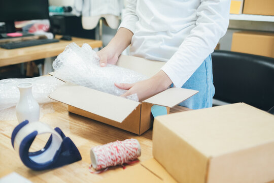 Online business owner preparing product to customer. 