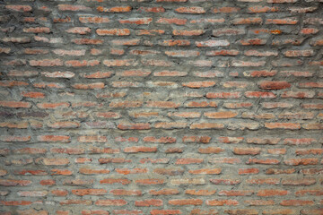 Red background of old vintage brick wall texture. Close up view of old stone brick wall with medieval masonry,