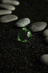 small sea pebbles are laid out on a black background