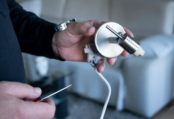  Close up man's hand holding electrich light  and changing light at home
