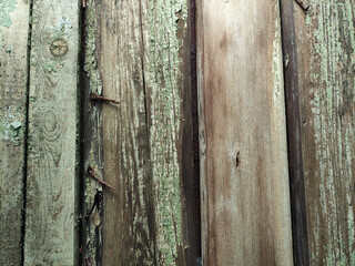 Old wooden planks with paint residues and rusty nails, background, texture