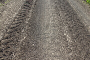 Traces of agricultural machinery in an agricultural field