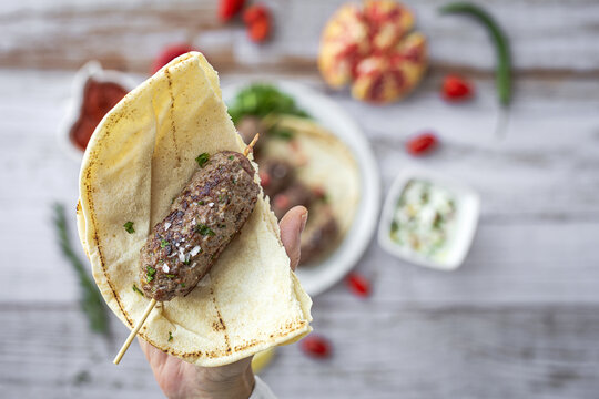 Traditional homemade kafta or kofta kebab with tomato sauce and yoghurt