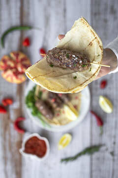 Traditional homemade kafta or kofta kebab with tomato sauce and yoghurt