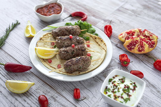 Traditional homemade kafta or kofta kebab with tomato sauce and yoghurt