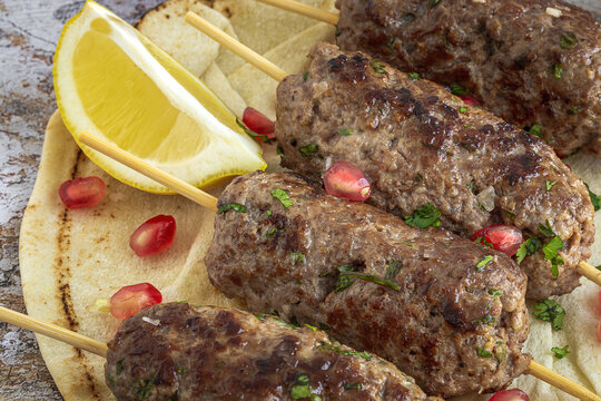 Traditional homemade kafta or kofta kebab with tomato sauce and yoghurt