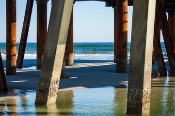 Closeup of Jacksonville Beach pier and support columns from underneath