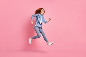 Full body photo of charming nice happy young woman look run jump empty space isolated on pink color background