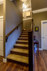 Beautiful living room interior with hardwood floors in new luxury home. View of stairs, and second story area.