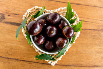 Jabuticaba, exotic Brazilian fruits on wooden table, Jaboticaba is a common fruit in South America