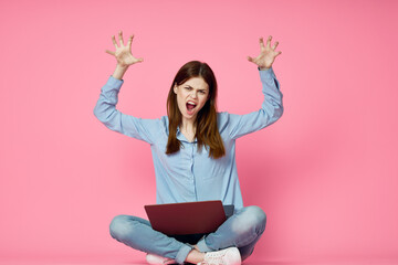 woman with laptop on pink background online shopping entertainment