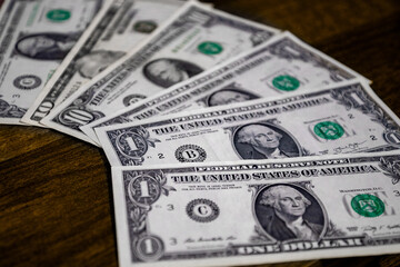 Few dollar banknotes spread out on the surface