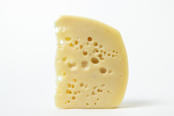Cheese isolated on a white background. Fresh cheese with holes.