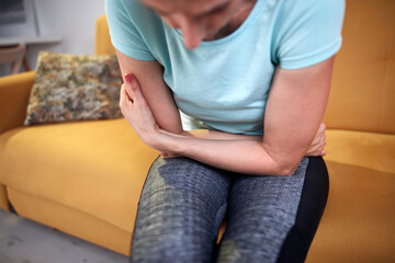 Woman with stomach pain at home.