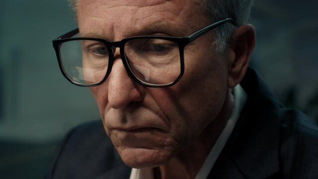 Portrait Of Senior Businessman Wearing Glasses Working On Laptop Indoor