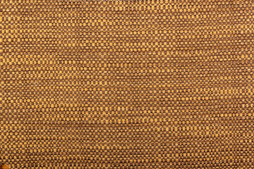 Factory fabric with brown and white threads interspersed. Close-up long and wide texture of natural fabric. Fabric texture of natural cotton or linen textile material.