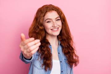 Photo of adorable friendly young lady dressed jeans shirt smiling inviting you come isolated pink color background