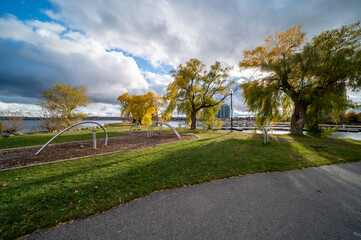 Barrie centennial park in the fall with green and yellow trees with clouds above 