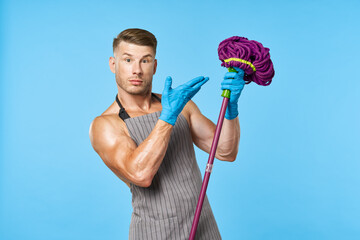 a man in an apron with a mop in his hands cleaning service